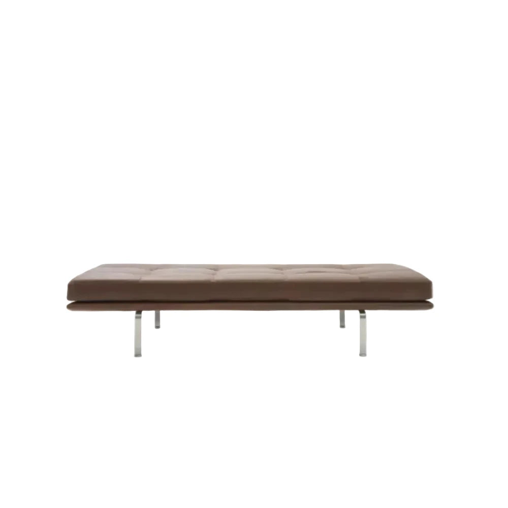 A modern brown tufted leather daybed with slim chrome legs, shown from a straight-on perspective against a solid white background.