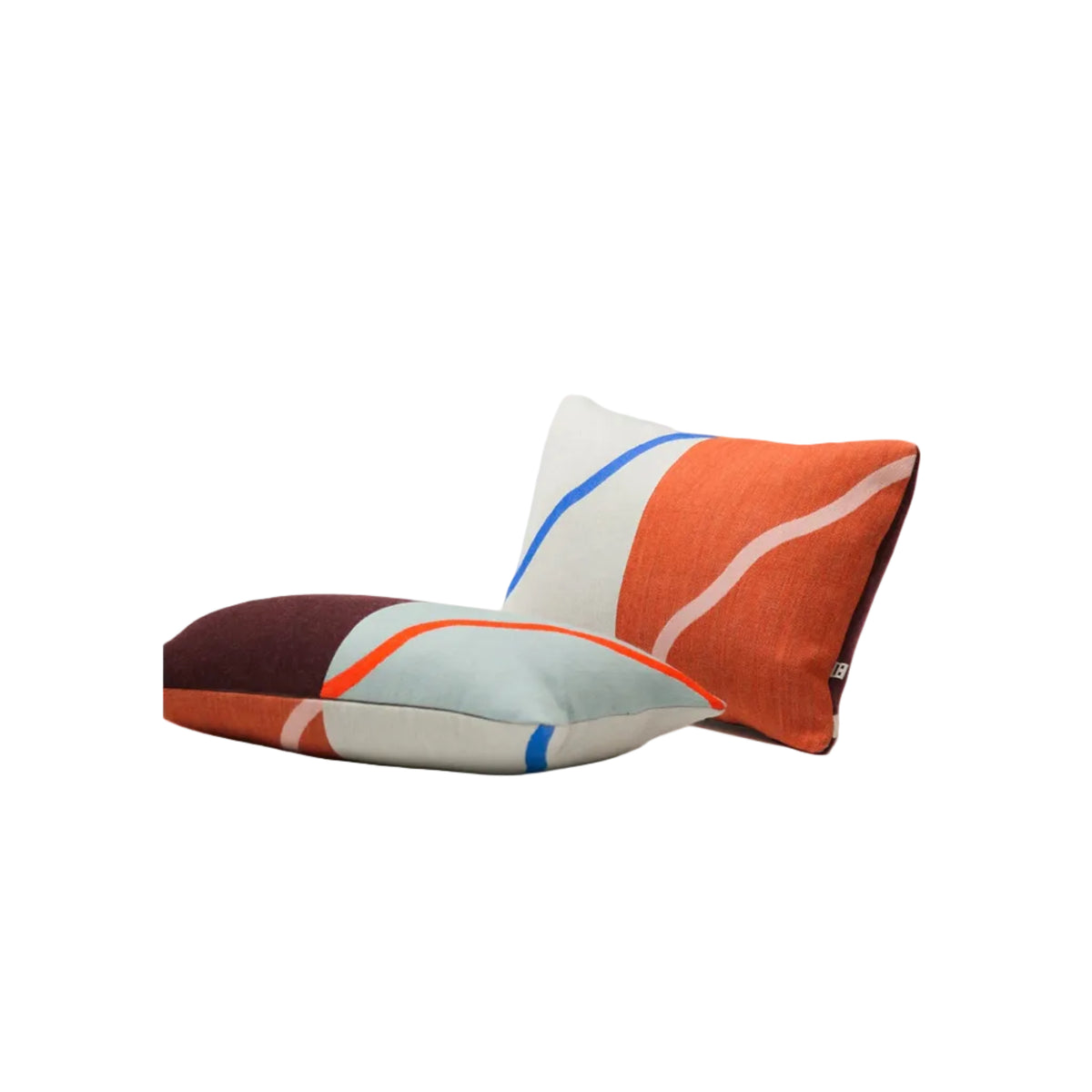 Two modern abstract throw pillows with a color-blocked design in orange, light blue, white, and dark burgundy, styled on a clean white surface against a light gray background.
