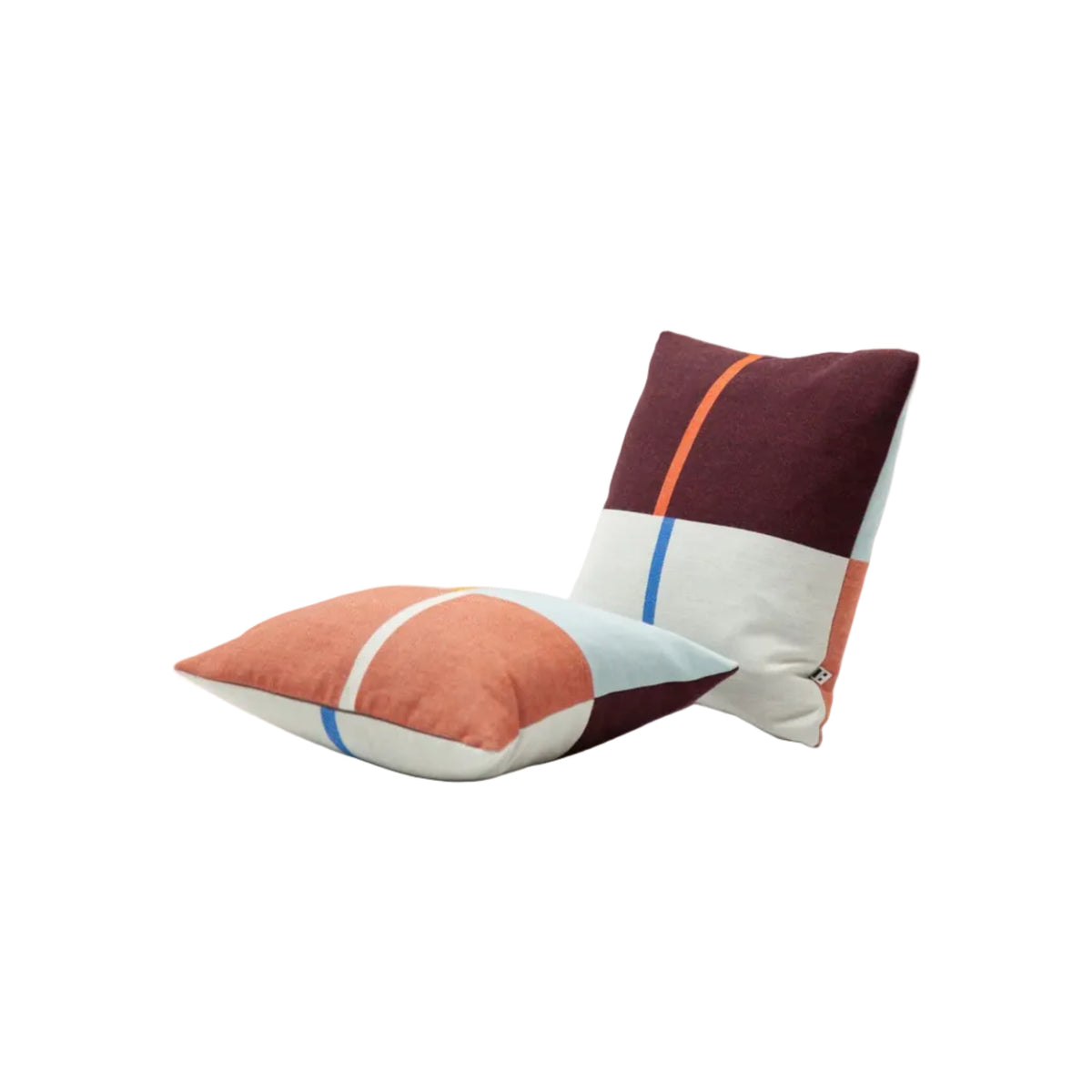 Two square throw pillows with a modern color-blocked patchwork design, displayed on a clean white studio background.