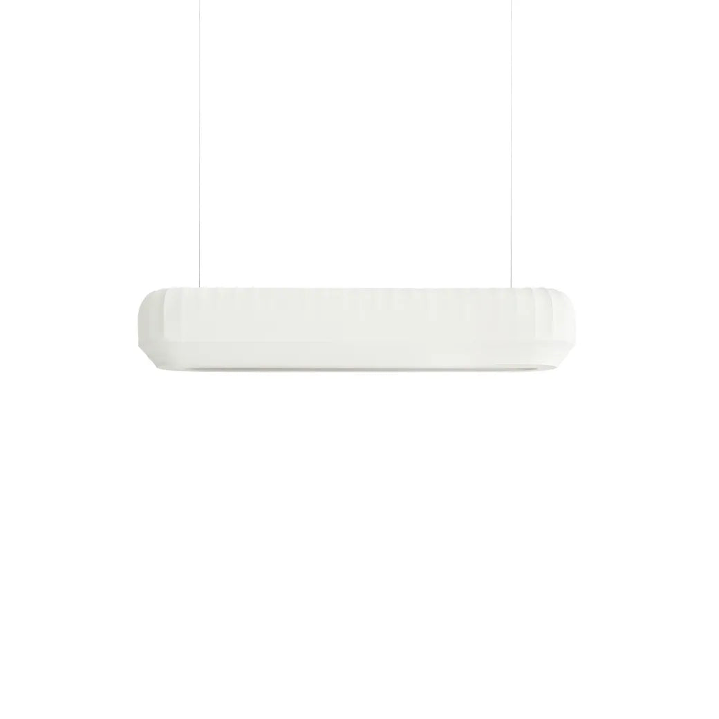 A modern horizontal linear pendant light fixture in white, suspended by two thin cables against a solid white background.